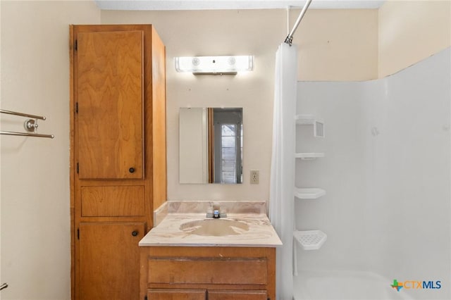 bathroom with vanity and curtained shower