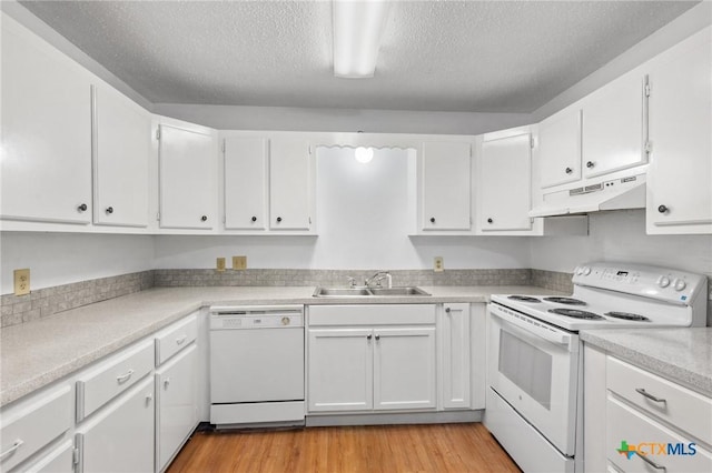 kitchen with sink, white appliances, a textured ceiling, white cabinets, and light wood-type flooring