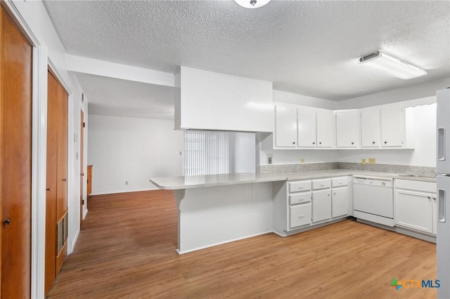 kitchen with dishwasher, light wood-type flooring, kitchen peninsula, and white cabinets