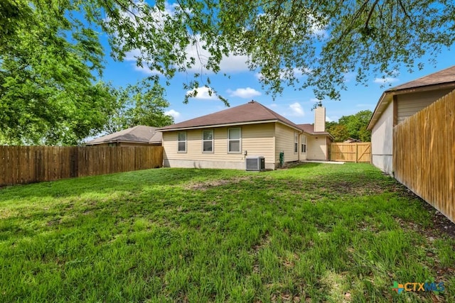 2121 Keystone Dr, New Braunfels, TX 78130 - rear view of property with central AC and a chimney