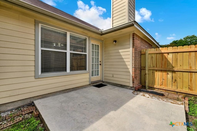2121 Keystone Dr, New Braunfels, TX 78130 - entrance to property featuring a patio, brick siding, a chimney, and fence