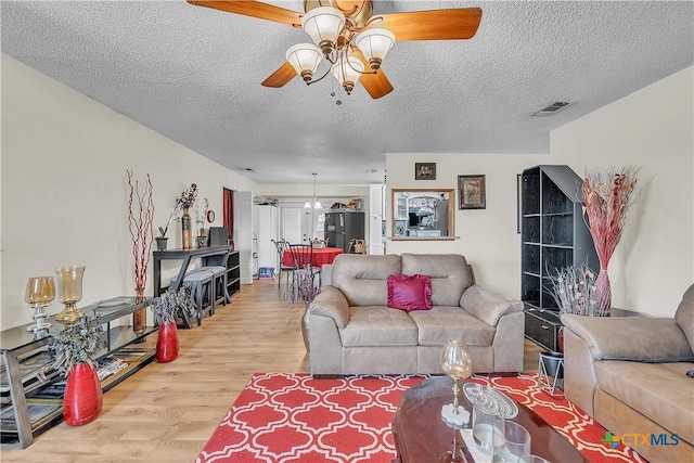 3602 Bacon Ranch Rd, Killeen, TX 76542 - living room with ceiling fan, wood finished floors, and a textured ceiling