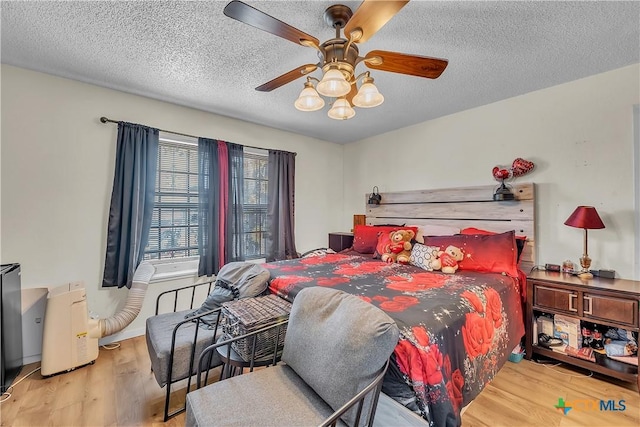 3602 Bacon Ranch Rd, Killeen, TX 76542 - bedroom with wood finished floors, a textured ceiling, and a ceiling fan
