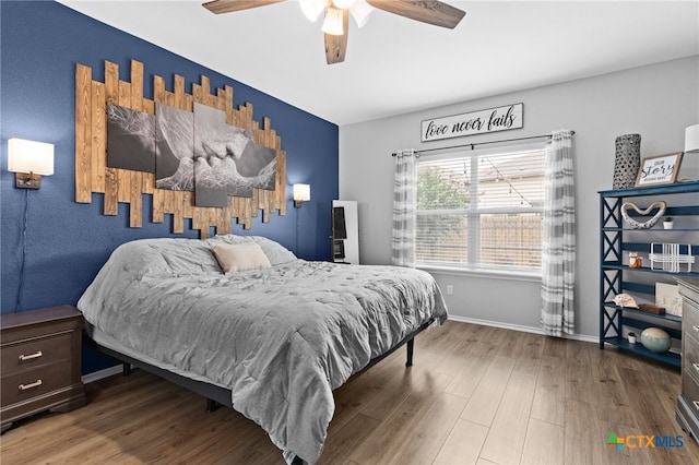 421 Perfect World Loop, Jarrell, TX 76537 - bedroom featuring wood finished floors, ceiling fan, and baseboards