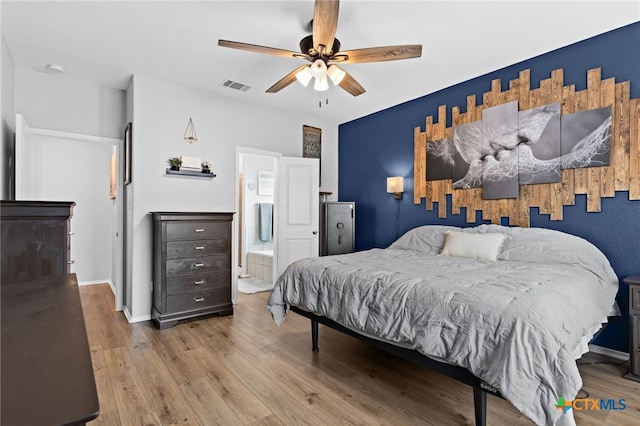 421 Perfect World Loop, Jarrell, TX 76537 - bedroom featuring wood finished floors, ceiling fan, connected bathroom, and baseboards
