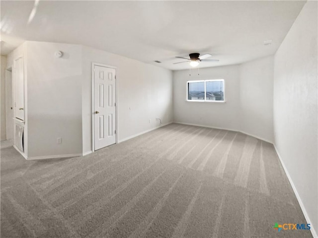 carpeted empty room with ceiling fan