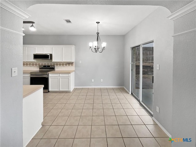 kitchen with decorative light fixtures, tasteful backsplash, a notable chandelier, white cabinetry, and stainless steel appliances