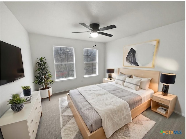 bedroom featuring ceiling fan and carpet