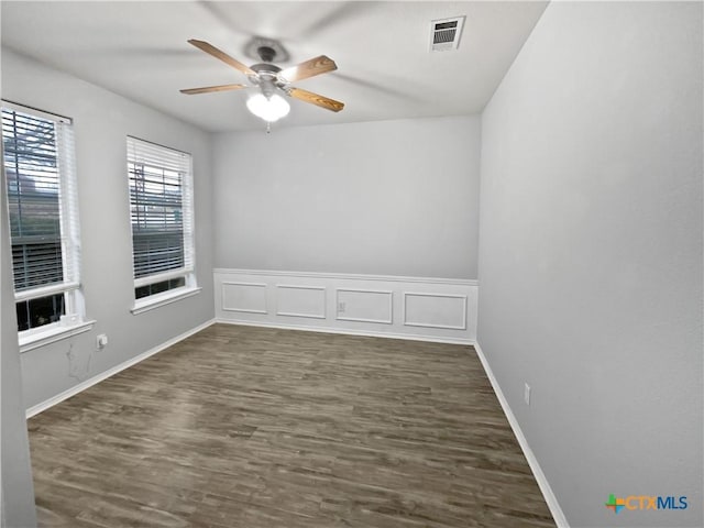 spare room featuring dark hardwood / wood-style floors and ceiling fan