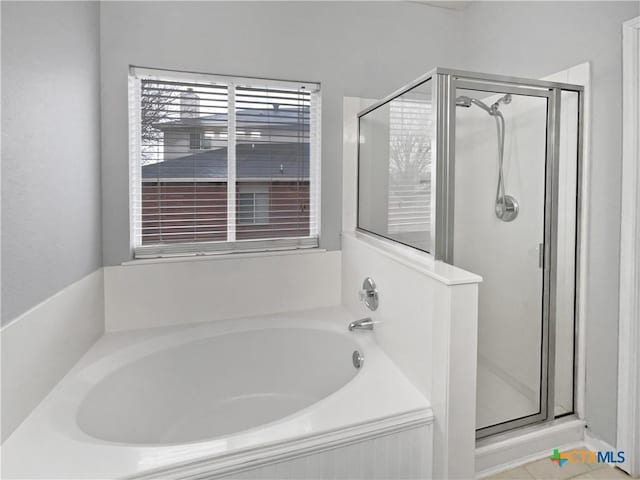 bathroom with shower with separate bathtub