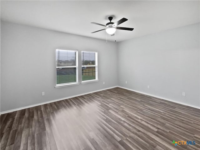 spare room with ceiling fan and dark wood-type flooring