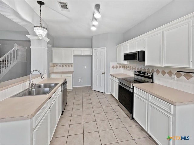 kitchen featuring white cabinets, stainless steel appliances, tasteful backsplash, and sink