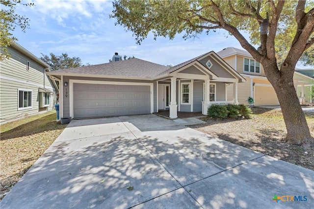 view of front facade featuring covered porch, concrete driveway, a shingled roof, and an attached garage