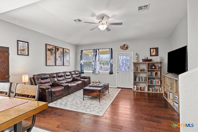 living room with ceiling fan and dark hardwood / wood-style flooring