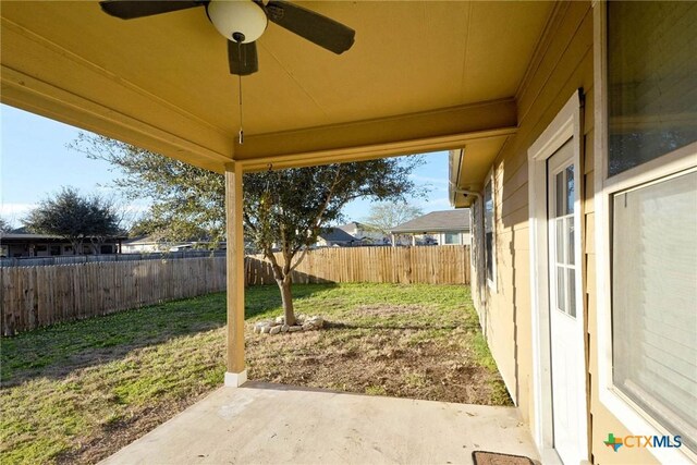 view of yard featuring a patio area, a fenced backyard, and ceiling fan