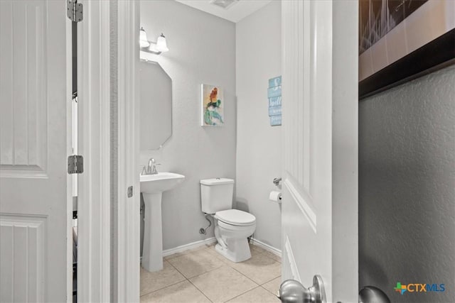 bathroom with sink, tile patterned flooring, and toilet