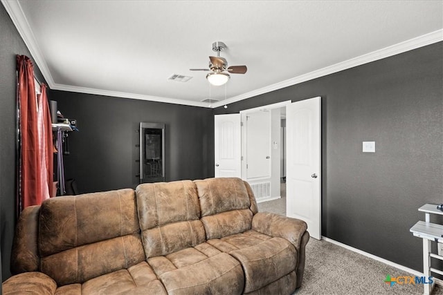 living room featuring carpet flooring, ceiling fan, and ornamental molding