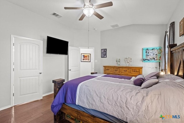 bedroom featuring visible vents, baseboards, lofted ceiling, wood finished floors, and a ceiling fan