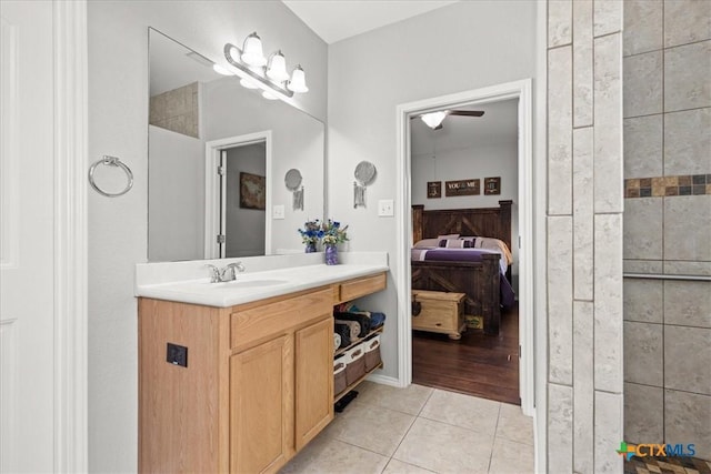 ensuite bathroom with tile patterned floors, connected bathroom, and vanity