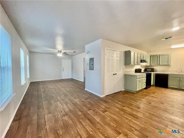1009-1019 Advance St, San Marcos, TX 78666 - kitchen with green cabinets, light countertops, a sink, visible vents, and black appliances