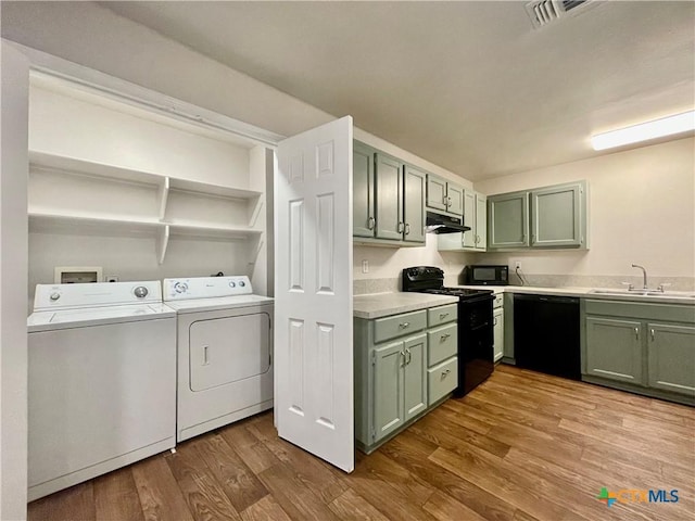 1009-1019 Advance St, San Marcos, TX 78666 - washroom featuring visible vents, wood finished floors, laundry area, a sink, and washer and dryer