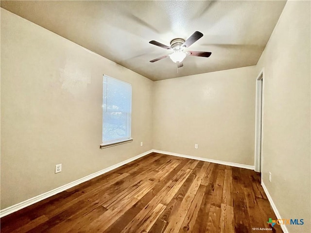1009-1019 Advance St, San Marcos, TX 78666 - empty room with baseboards, ceiling fan, and dark wood finished floors