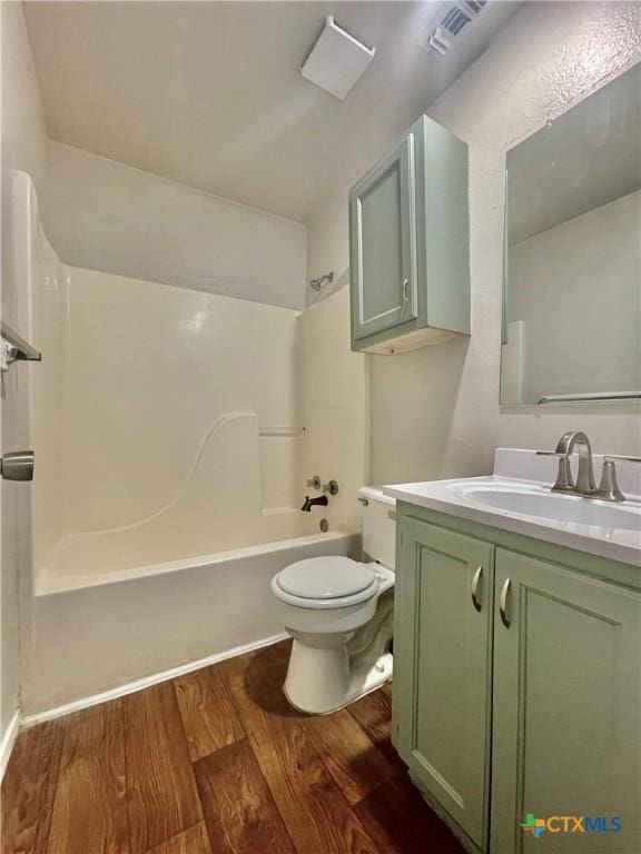1009-1019 Advance St, San Marcos, TX 78666 - bathroom featuring toilet, vanity, wood finished floors, tub / shower combination, and visible vents