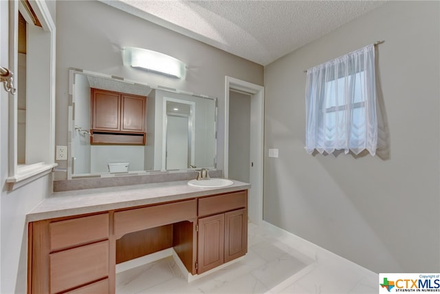 bathroom with vanity and a textured ceiling