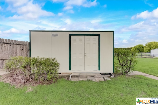 view of outbuilding with a lawn