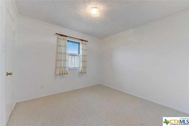 unfurnished room featuring ornamental molding, carpet floors, and a textured ceiling