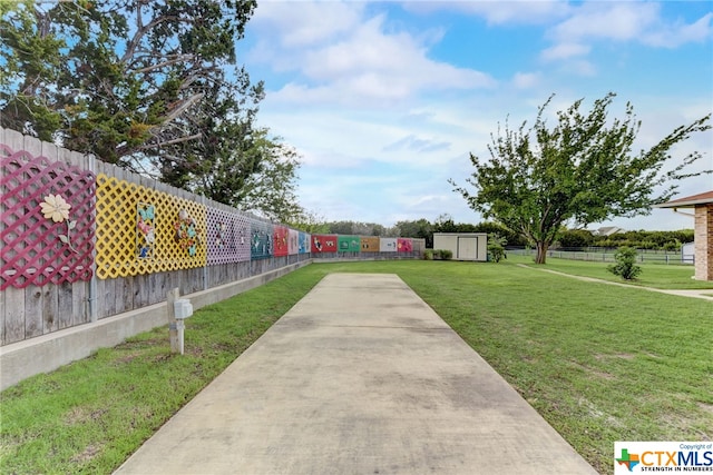 surrounding community featuring a yard and a storage shed