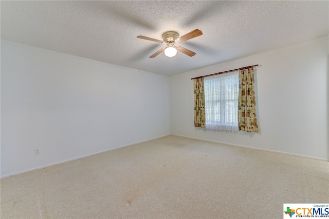 empty room with carpet, a textured ceiling, and ceiling fan