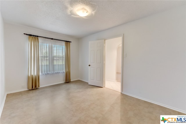 empty room featuring a textured ceiling