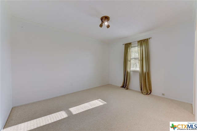 unfurnished room with light colored carpet