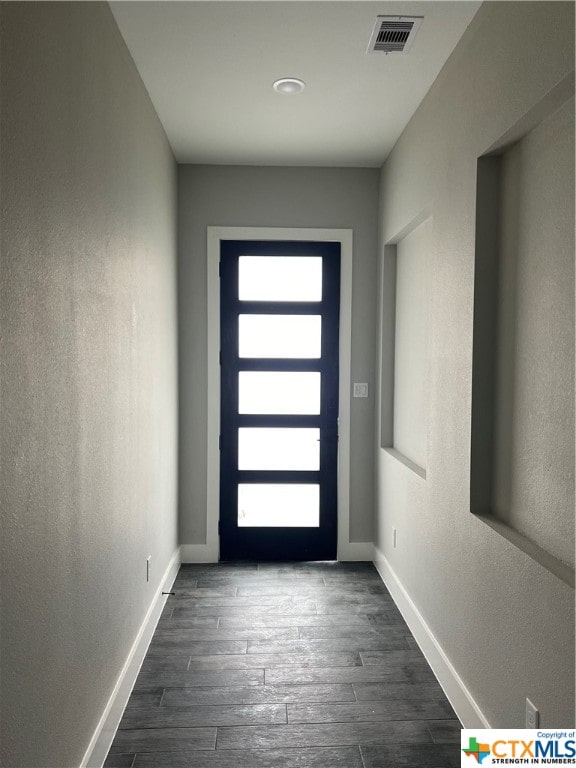 entryway with dark hardwood / wood-style flooring