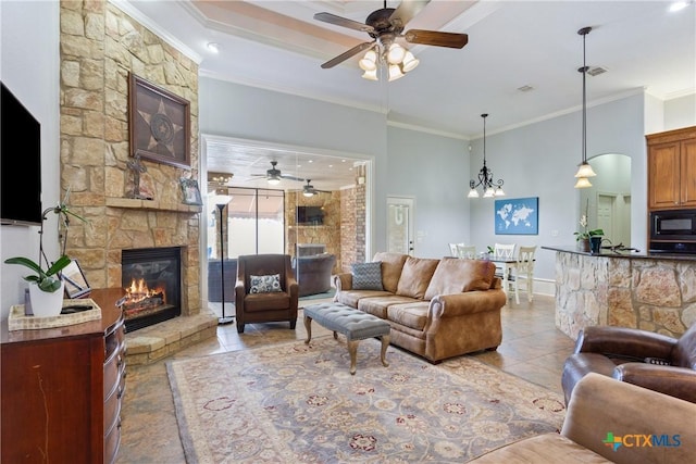 1332 Walker Cir, Salado, TX 76571 - living room featuring a ceiling fan, a stone fireplace, ornamental molding, tile patterned flooring, and baseboards