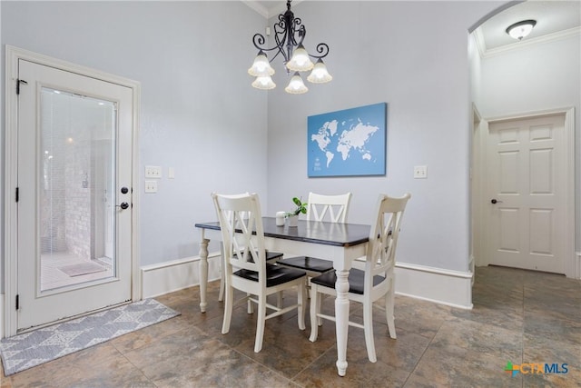 1332 Walker Cir, Salado, TX 76571 - dining room with ornamental molding, stone finish flooring, baseboards, a chandelier, and arched walkways