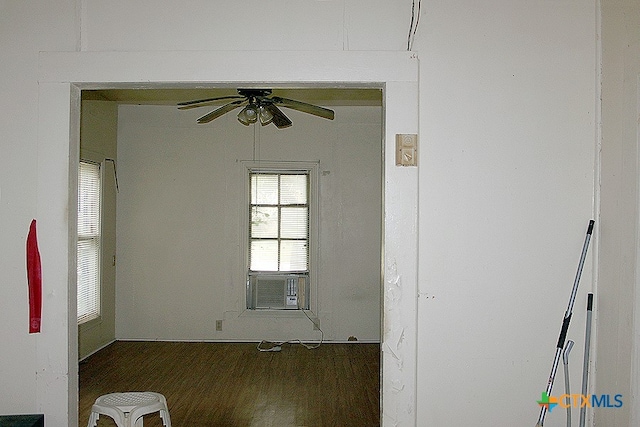 empty room with ceiling fan, cooling unit, and dark hardwood / wood-style floors