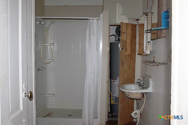 bathroom featuring walk in shower, sink, and gas water heater