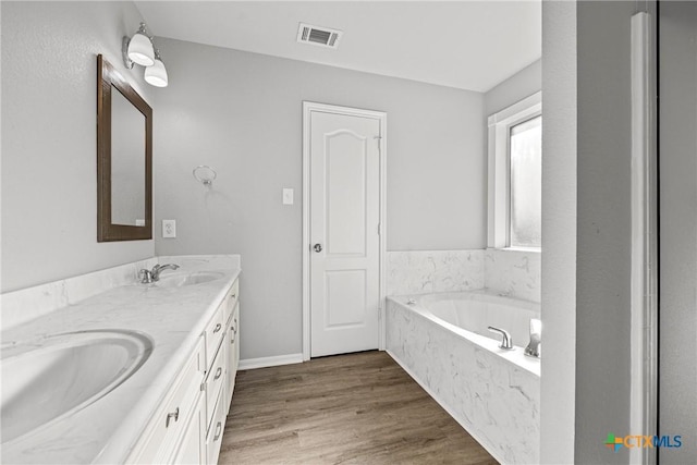 3705 Armstrong County Ct, Killeen, TX 76549 - full bathroom featuring double vanity, a bath, and wood finished floors