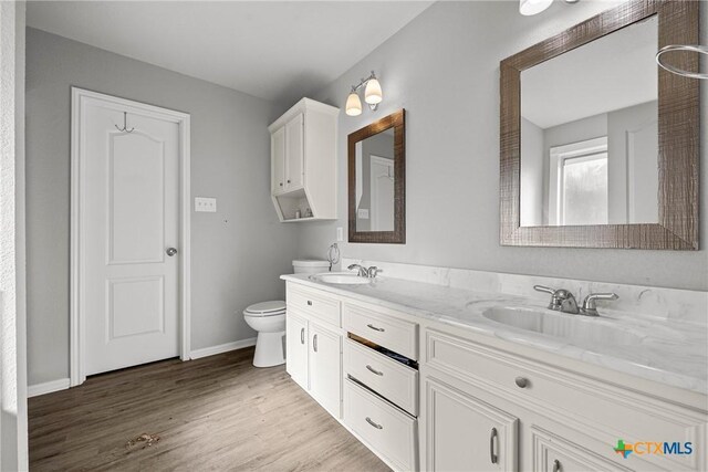 3705 Armstrong County Ct, Killeen, TX 76549 - bathroom featuring toilet, wood finished floors, double vanity, and baseboards