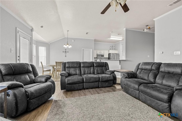 3705 Armstrong County Ct, Killeen, TX 76549 - living area featuring light wood-style flooring, ceiling fan, lofted ceiling, crown molding, and a chandelier