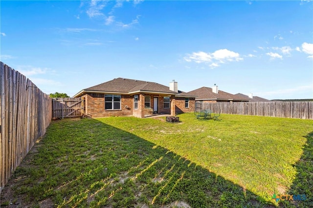 3705 Armstrong County Ct, Killeen, TX 76549 - rear view of house featuring brick siding, a chimney, a gate, and an outdoor fire pit
