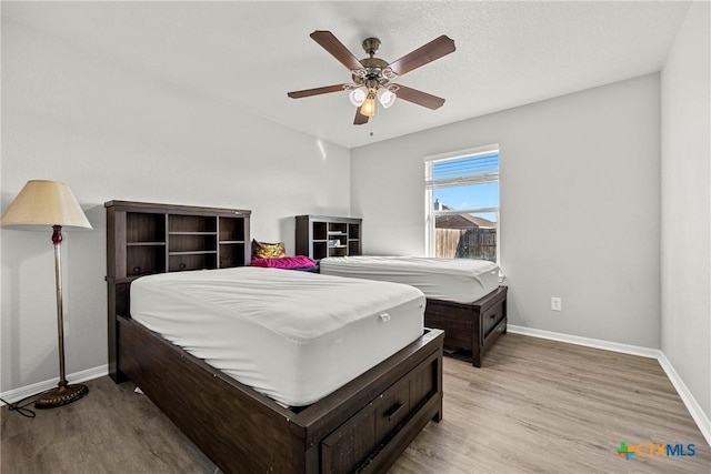 3705 Armstrong County Ct, Killeen, TX 76549 - bedroom with baseboards, light wood finished floors, and a ceiling fan