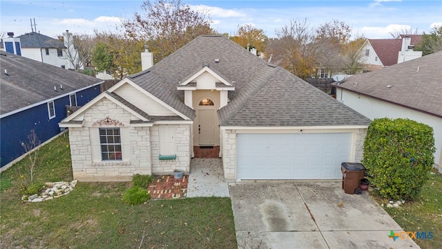 view of front of house with a front yard and a garage