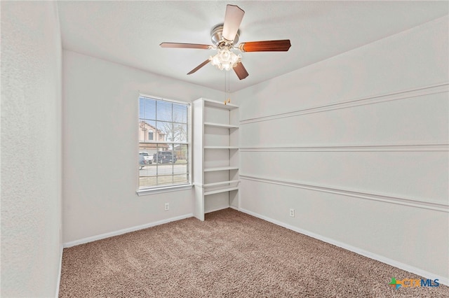 empty room with ceiling fan and carpet floors