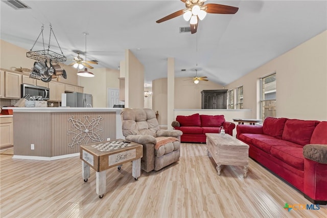 living room featuring light hardwood / wood-style flooring and lofted ceiling