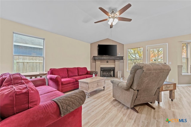 living room with vaulted ceiling, ceiling fan, and light hardwood / wood-style floors