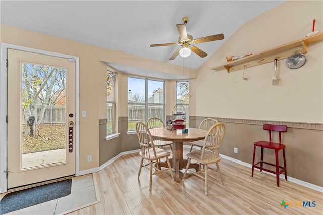 dining space with lofted ceiling, ceiling fan, and light hardwood / wood-style floors