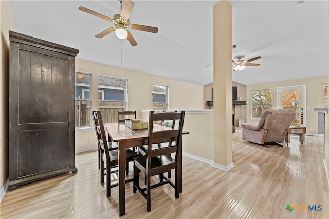 dining room featuring ceiling fan, light hardwood / wood-style floors, and lofted ceiling